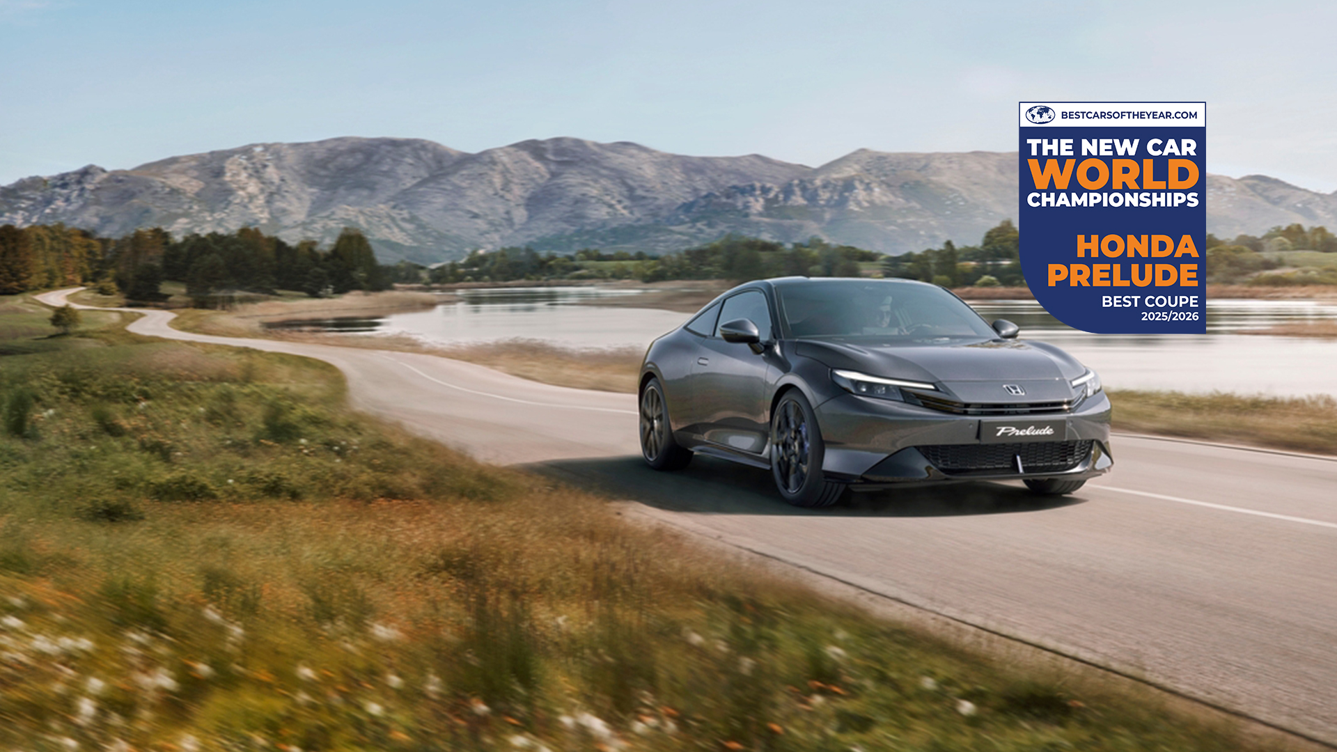 Honda prelude 2026 in grey, along a scenic mountain road with the award logo in the background